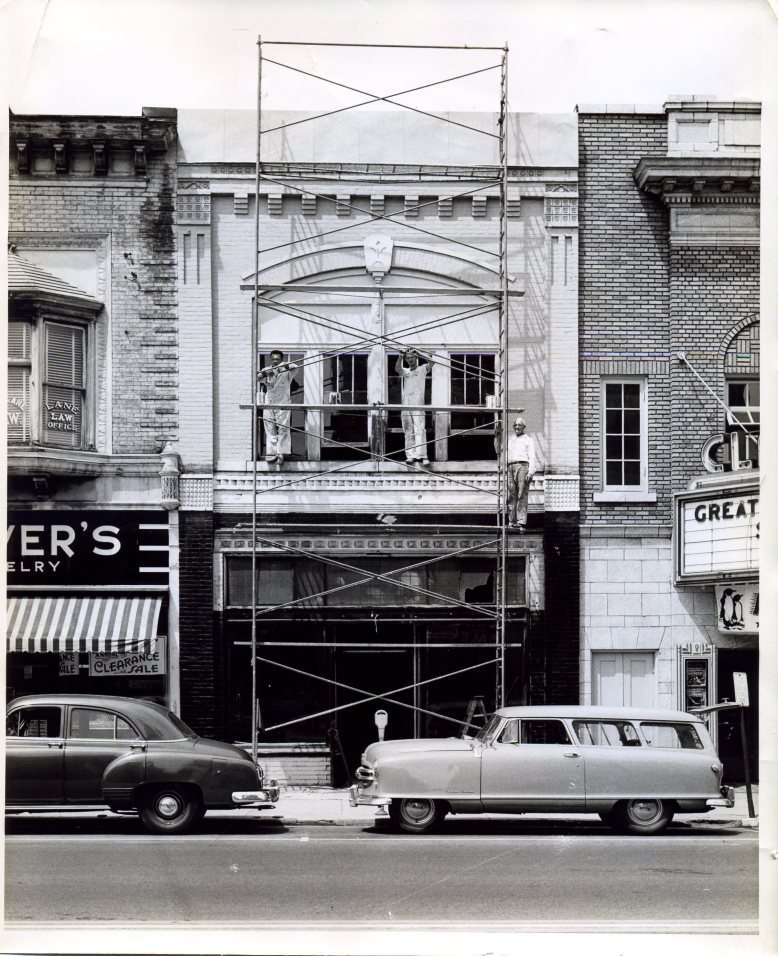 Richard, Floyd, and Emil Wilkens painting with brushes on Main Street, Bowling Green, Ohio. Photograph. 1950s. The Wilkens Family Collection.